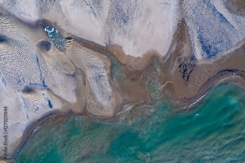 High-angle view of intricate sand patterns meeting turquoise water. Coastal erosion and tide pools. Nature's artistry. , Pauanui, Coromandel Peninsula, New Zealand