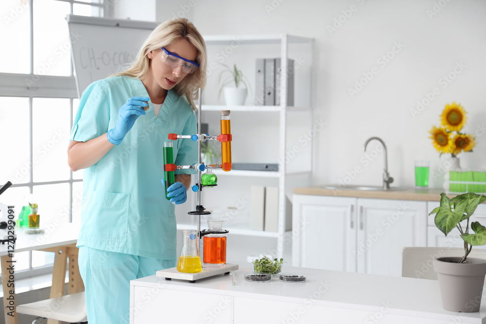 Female scientist with flasks of samples, sunflower seeds and sprouts working in laboratory Female scientist with flasks of samples, sunflower seeds and sprouts working in laboratory