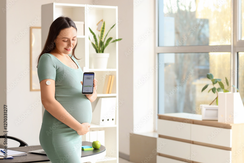 Young pregnant businesswoman with glucose sensor and mobile phone in office. Gestational diabetes concept Young pregnant businesswoman with glucose sensor and mobile phone in office. Gestational diabetes concept