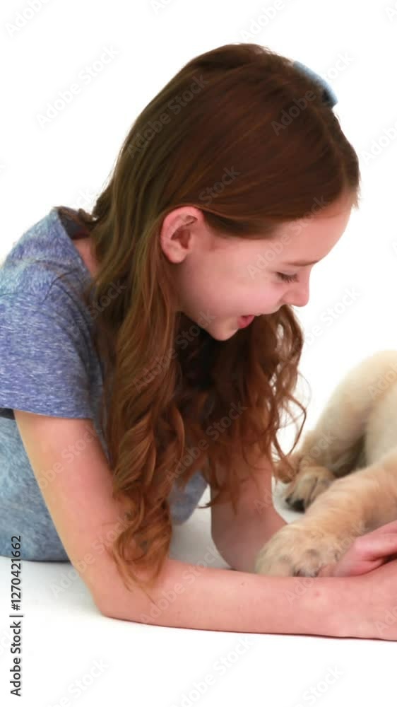 Smiling girl playing with cute puppy Smiling girl playing with cute puppy