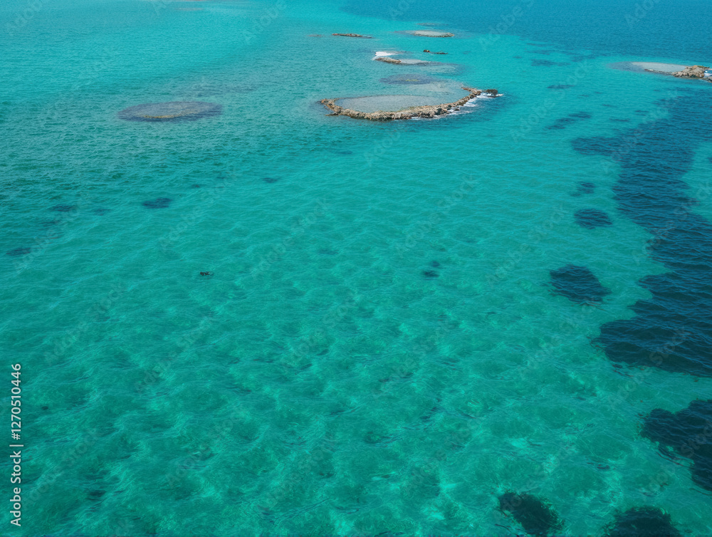 Fototapeta premium Aerial view of azure seascape with coral reefs and turquoise water in tranquil ocean