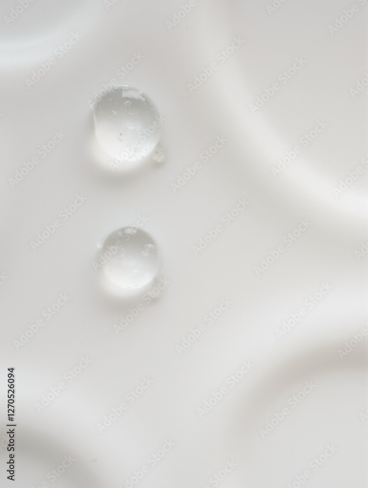 Close-up of water droplets on smooth white surface with circular patterns Close-up of water droplets on smooth white surface with circular patterns