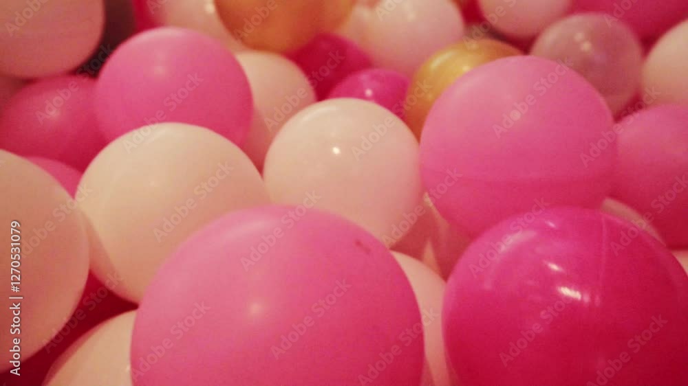 Mesmerizing ball pit scene with soft pink, gold, white tones, celebrations Mesmerizing ball pit scene with soft pink, gold, white tones, celebrations