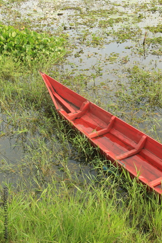 Fishing boats on the shores of Rawa Pening lake on the edge of the swamp and the background of the Merbabu and Telomoyo in the Ambarawa Basin in Central Java, Indonesia. photo