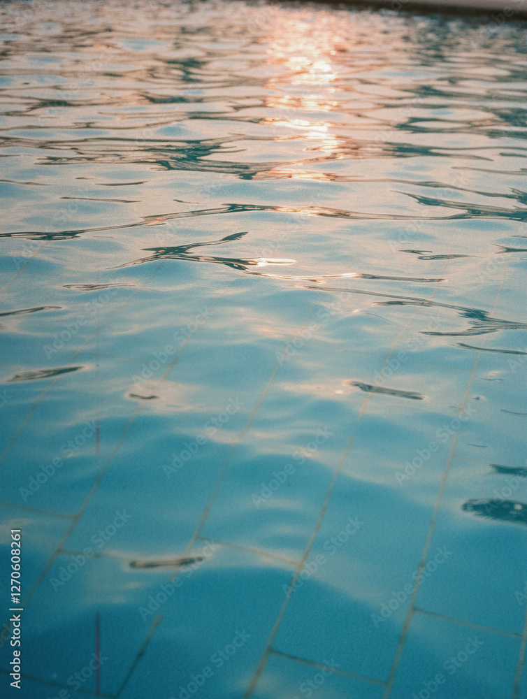 Tranquil sunset reflections on serene pool water surface Tranquil sunset reflections on serene pool water surface