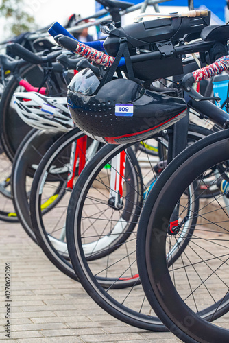 Road Cycling Concepts. View of Professional Carbon Road Bikes With Deep Profile Carbon Aero Wheelset Placed Together During Triathlon