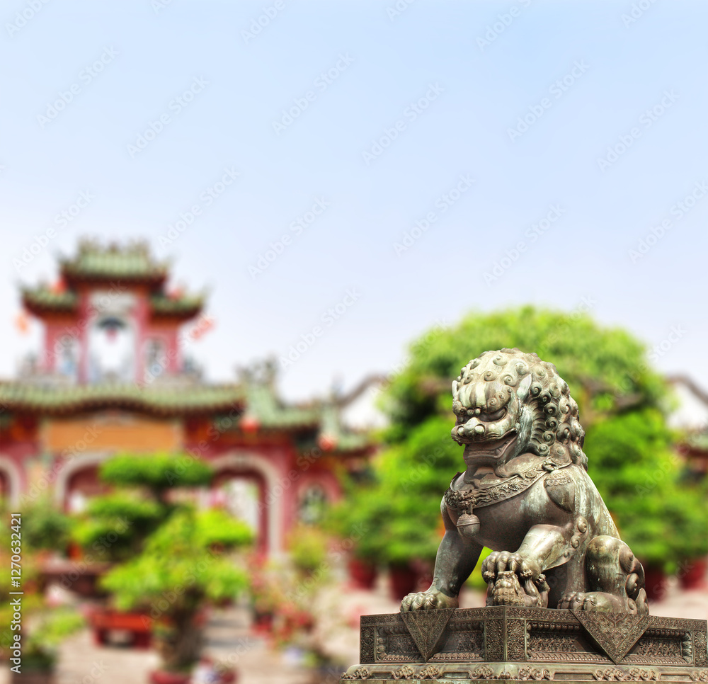 Horizontal background with chinese temple, trees and ancient lion statue. Bronze guardian lion and picturesque landscape, China. Topic of vacation, travel, trip abroad on vacation, cruises, tours Horizontal background with chinese temple, trees and ancient lion statue. Bronze guardian lion and picturesque landscape, China. Topic of vacation, travel, trip abroad on vacation, cruises, tours