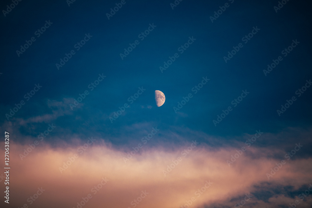 Half Moon in a Colorful Twilight Sky with Soft Clouds Half Moon in a Colorful Twilight Sky with Soft Clouds