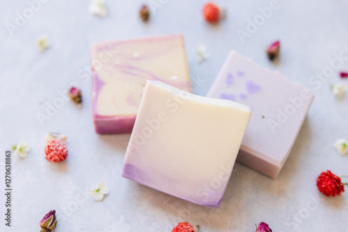 Obraz na plátně Three handmade pastel soaps with floral decorations and swirls