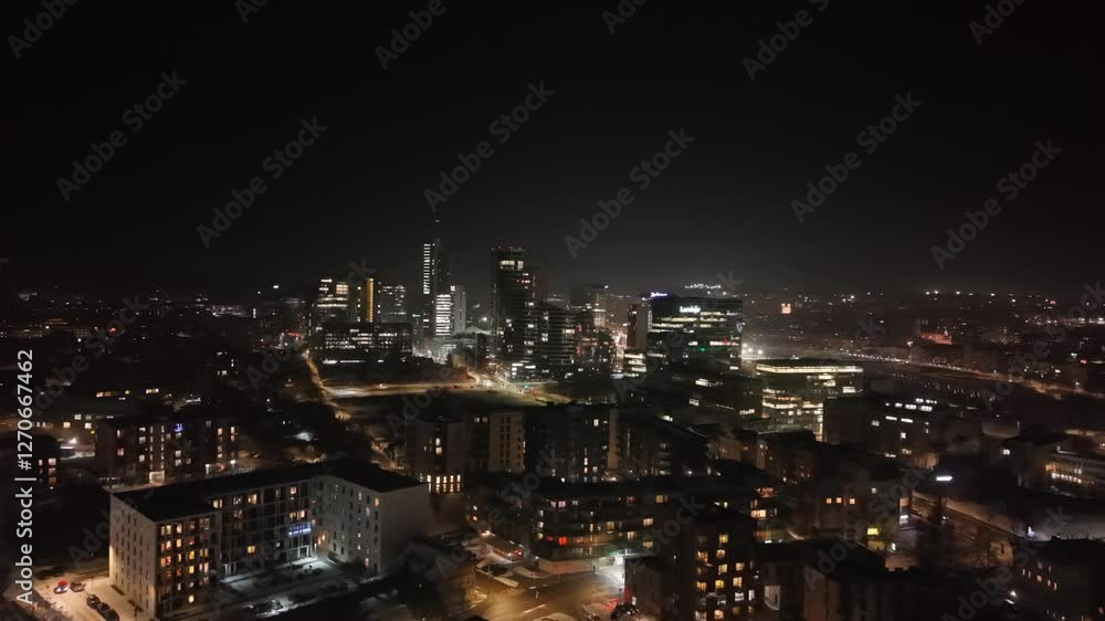 Stunning aerial night view of Vilnius, Lithuania, showing modern skyscrapers, city lights, and busy streets Stunning aerial night view of Vilnius, Lithuania, showing modern skyscrapers, city lights, and busy streets