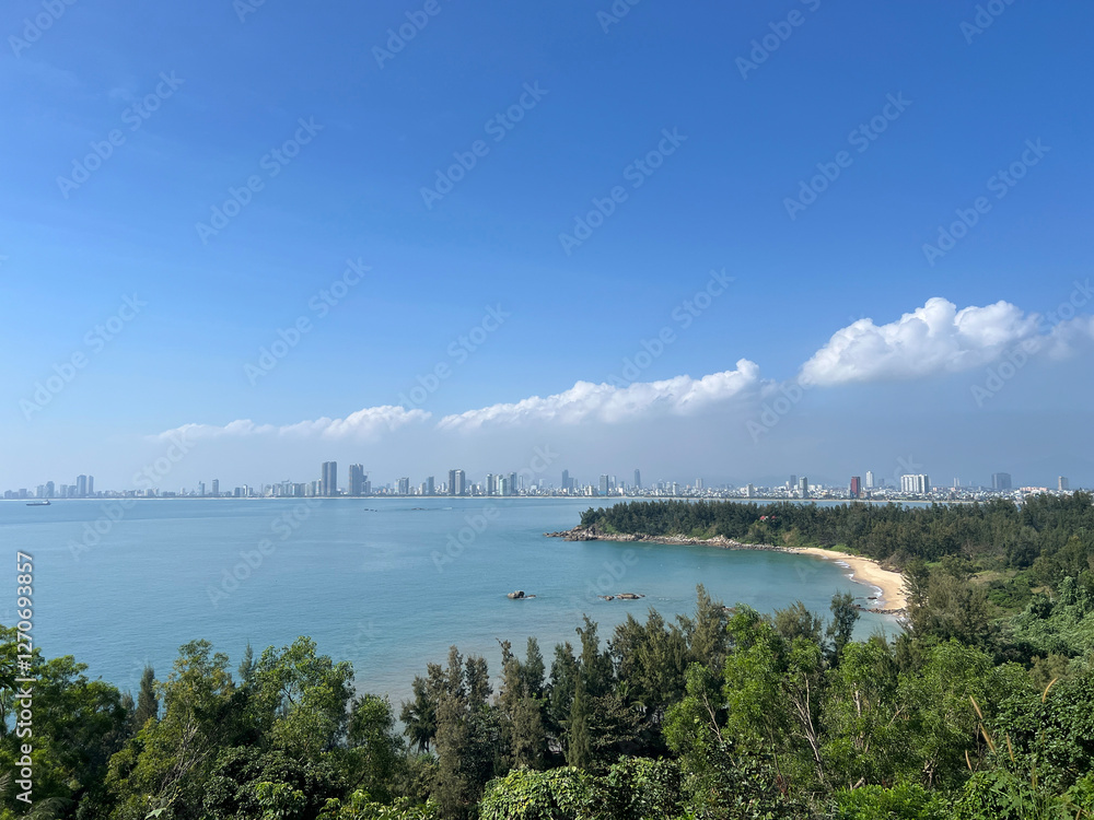 Bay and beach with the city Da Nang in the background