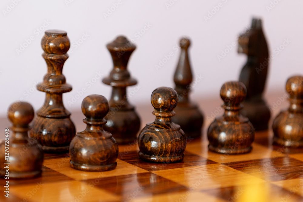 Wooden black chess pieces on the chessboard Wooden black chess pieces on the chessboard