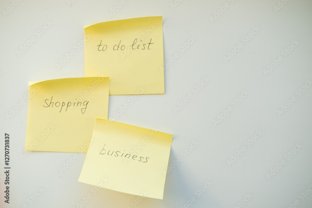Notes reminders of yellow colored stickers with text on the table. Many unfulfilled tasks, deadlines. Top view Notes reminders of yellow colored stickers with text on the table. Many unfulfilled tasks, deadlines. Top view