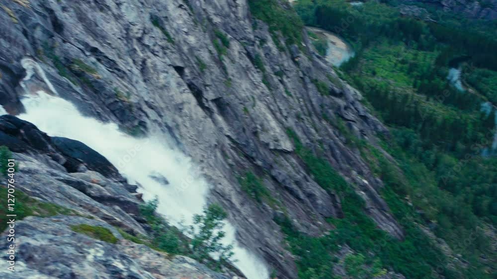 Waterfall Cascading Down Cliffs In Rago National Park, Norway - Panning Shot Waterfall Cascading Down Cliffs In Rago National Park, Norway - Panning Shot