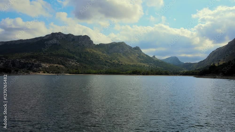 Discover the breathtaking beauty of Gorg Blau, a serene reservoir nestled in the Sierra de Tramuntana mountains of Mallorca. Marvel at the striking landscape and tranquil waters. Discover the breathtaking beauty of Gorg Blau, a serene reservoir nestled in the Sierra de Tramuntana mountains of Mallorca. Marvel at the striking landscape and tranquil waters.