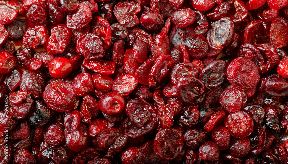 Repeating pattern of dried cranberries, highlighting their chewy texture and deep red color. Ideal for healthy snacks, baking, or festive themes. Texture, background. Repeating pattern of dried cranberries, highlighting their chewy texture and deep red color. Ideal for healthy snacks, baking, or festive themes. Texture, background.