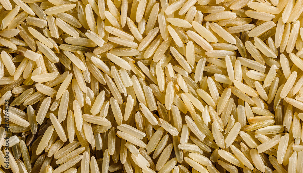 Repeating pattern of uncooked rice grains, highlighting their small, elongated shape and white or brown color. Ideal for Asian cuisine, cooking, or minimalist concepts. Texture, background. Repeating pattern of uncooked rice grains, highlighting their small, elongated shape and white or brown color. Ideal for Asian cuisine, cooking, or minimalist concepts. Texture, background.