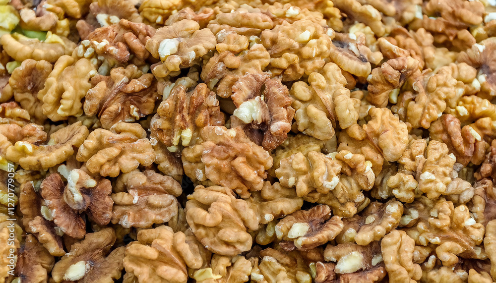 Background featuring peeled walnuts texture, showcasing their smooth surface and light brown color. Ideal for healthy snacks, baking, or natural food concepts. Texture, background. Background featuring peeled walnuts texture, showcasing their smooth surface and light brown color. Ideal for healthy snacks, baking, or natural food concepts. Texture, background.