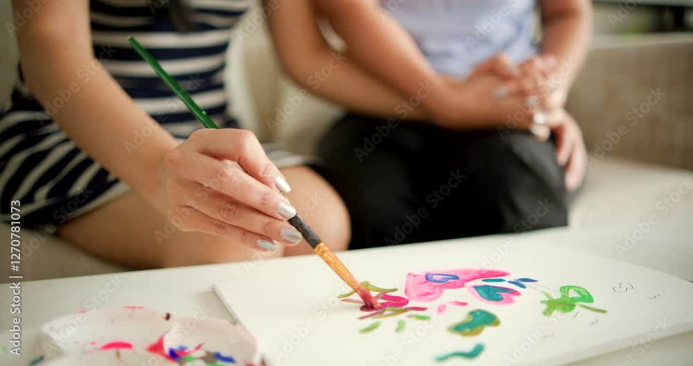 Creative painting session with colorful designs in a cozy living room Creative painting session with colorful designs in a cozy living room