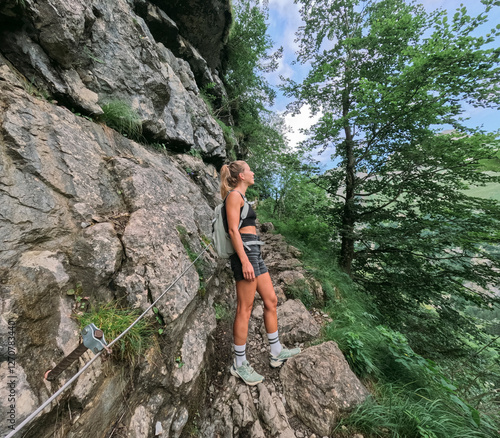 Woman standing on mountain at hiking trip photo