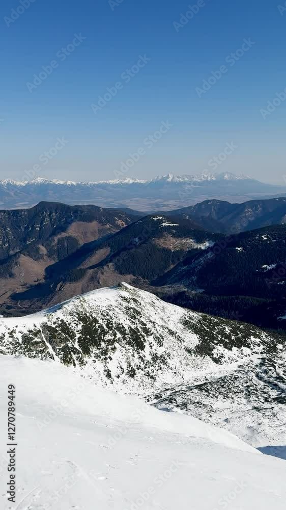 Ski resort, horizon view of snow-capped mountains and backcountry on a sunny day, mountain valley, vertical video. Ski resort, horizon view of snow-capped mountains and backcountry on a sunny day, mountain valley, vertical video.