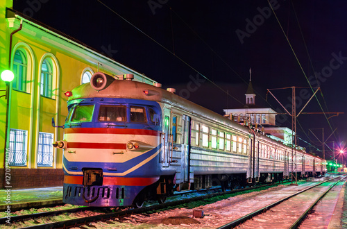 Old soviet electric commuter train on a winter night at Kovel station in Volyn Oblast of Ukraine photo