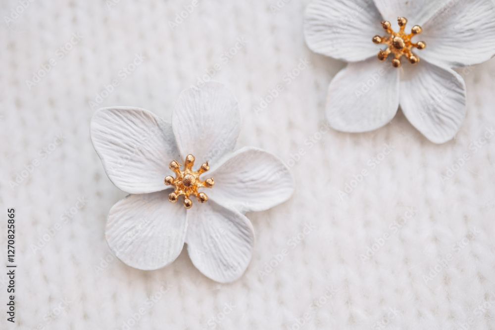 Delicate white flowers with golden centers on textured background Delicate white flowers with golden centers on textured background