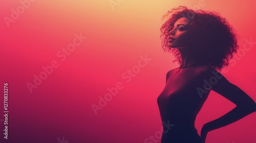 Portrait of a woman silhouetted against vibrant orange light in a modern space