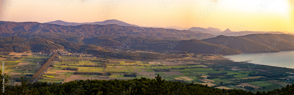 Fototapeta premium Cityscape from Sakartepe viewpoint at sunset with Aegean sea and mountains not far from Marmaris. Mugla, Turkey