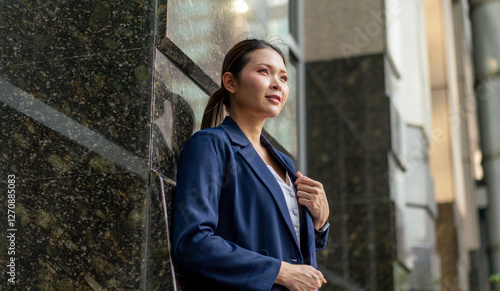 Confident Asian Businesswoman Looking Forward with Determination. Professional Corporate Portrait of Modern Executive in Urban Office Setting