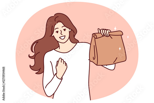 Woman with paper bag making victory gesture demonstrating food ordered from restaurant with delivery. Takeaway package for food or drinks in hand of girl delighted with purchase of delicious lunch