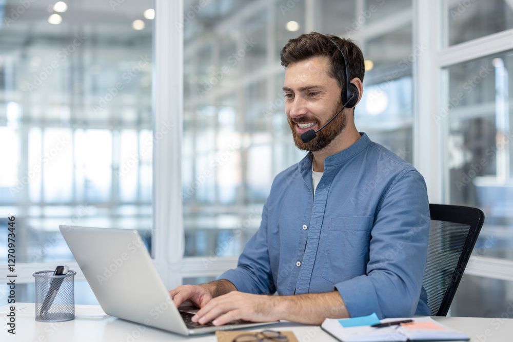 Man with headset working inside office with laptop, using video call for online communication remotely. Support service worker, and assistance at workplace. Man with headset working inside office with laptop, using video call for online communication remotely. Support service worker, and assistance at workplace.
