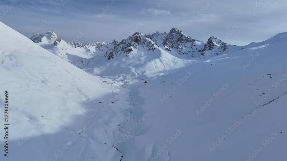Remote snowy mountain valley in Turkey with frozen river and peaks Remote snowy mountain valley in Turkey with frozen river and peaks