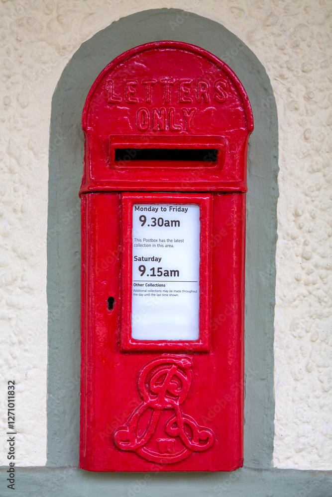 Edwardian postbox set into a wall. Traditional red British letter box from the era of Edward VII with his personal royal cypher. Post boxes have been painted red since 1884 to increase visibility. Edwardian postbox set into a wall. Traditional red British letter box from the era of Edward VII with his personal royal cypher. Post boxes have been painted red since 1884 to increase visibility.
