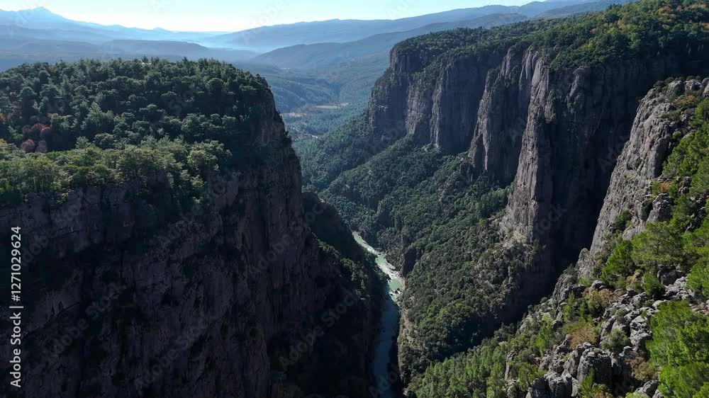Scenic canyon with a winding river flowing through steep cliffs Scenic canyon with a winding river flowing through steep cliffs