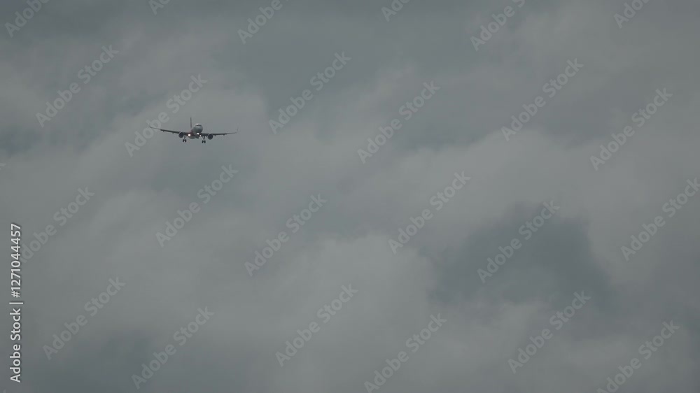 Close up of big airplane is landing in sunset sky with blue dramatic clouds Close up of big airplane is landing in sunset sky with blue dramatic clouds
