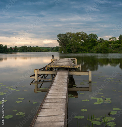 Quiet evening near the old pier with masonry on the pond, Zbarazh, Ternopil r...