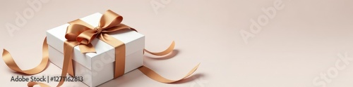 White gift box with a long brown ribbon tied around it and adorned with a small wooden bow, decorative item, ribbon
