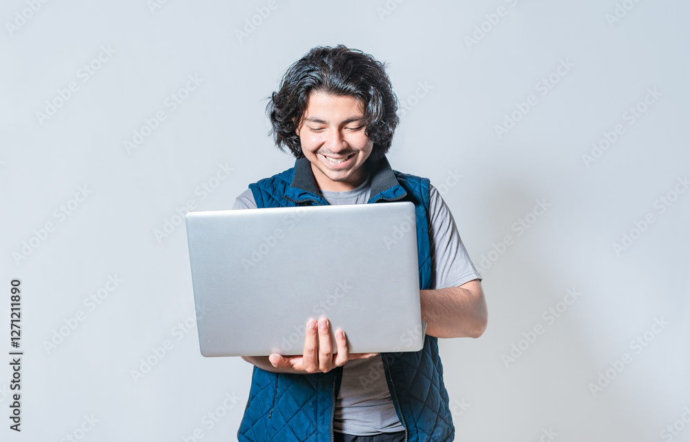 Happy guy using laptop isolated. Smiling handsome man looking at a promotion on laptop isolated Happy guy using laptop isolated. Smiling handsome man looking at a promotion on laptop isolated