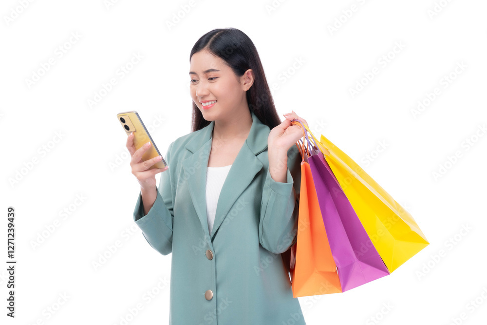 Beautiful Asian woman in a green blazer holding colorful shopping bags and using a smartphone, smiling with excitement while shopping online, isolated on a transparent background
