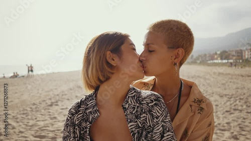 Beautiful multiethnic lesbian couple of lovers dating outdoors - LGBT people bonding and spending time together, concepts about LGBTQ community, diversity, love and lifestyle