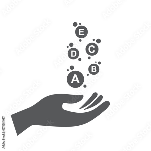 Silhouettes of hand catching pills and capsules - Vitamin A, Vitamin B, Vitamin C, Vitamin D, Vitamin E.