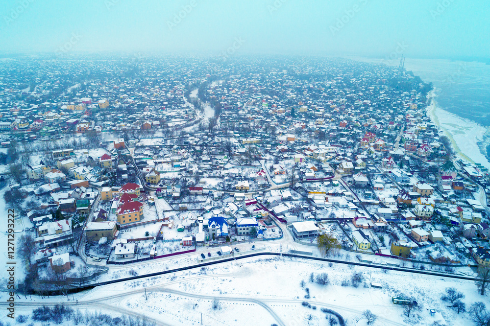 Skyline in a foggy morning, suburban town, residential area of Kyiv city in snowstorm. Aerial view of the cityscape on the left bank of the Dnieper River