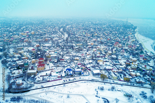 Obraz na płótnie Skyline in a foggy morning, suburban town, residential area of Kyiv city in snowstorm. Aerial view of the cityscape on the left bank of the Dnieper River w salonie