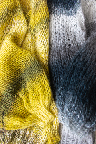 Obraz na płótnie Gradient coloured knitting sweaters. Yellow and grey wool yarn cardigan. Knitting pattern background. Knitting lifestyle. Cozy hobby. Warm knitwear. Craft product concept. w salonie