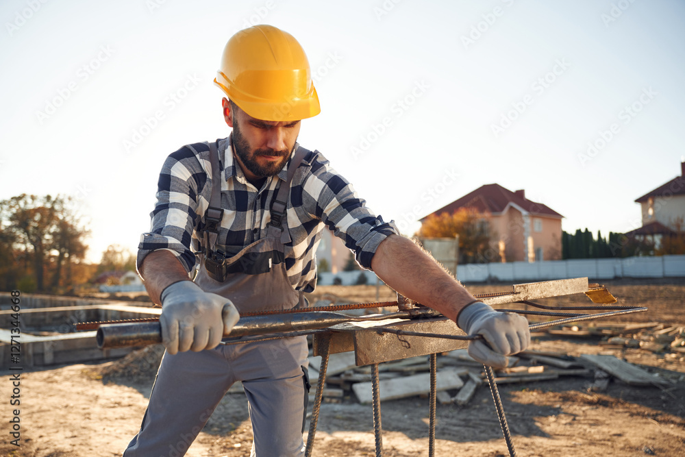 Metal rog, busy. Worker is on the construction site at daytime Metal rog, busy. Worker is on the construction site at daytime