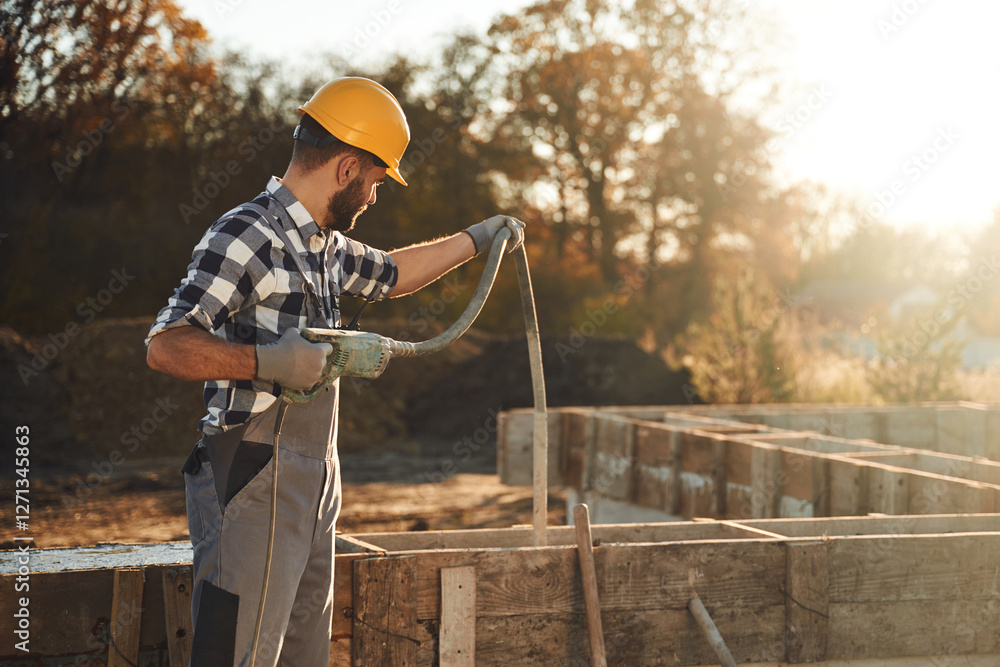 Worker is on the construction site at daytime Worker is on the construction site at daytime