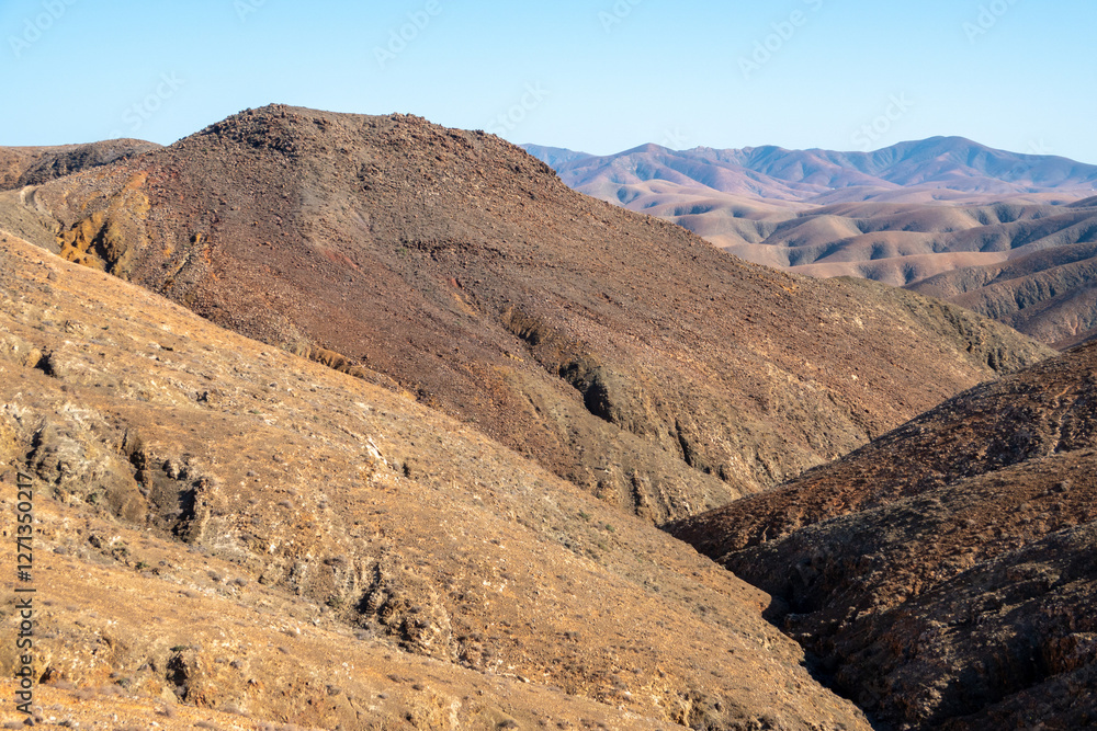 The rugged countryside of Fuerteventura with volcanic mountains. The rugged countryside of Fuerteventura with volcanic mountains.