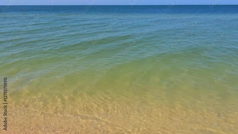 Waves onto sandy beach in clear weather. Warm sand meets blue, turquoise sea. Video quick time lapse calm, clear weather. Horizontal video 4k. Waves onto sandy beach in clear weather. Warm sand meets blue, turquoise sea. Video quick time lapse calm, clear weather. Horizontal video 4k.