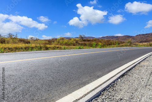 Obraz na płótnie Asphalt road and white cloud natural landscape under the blue sky w salonie